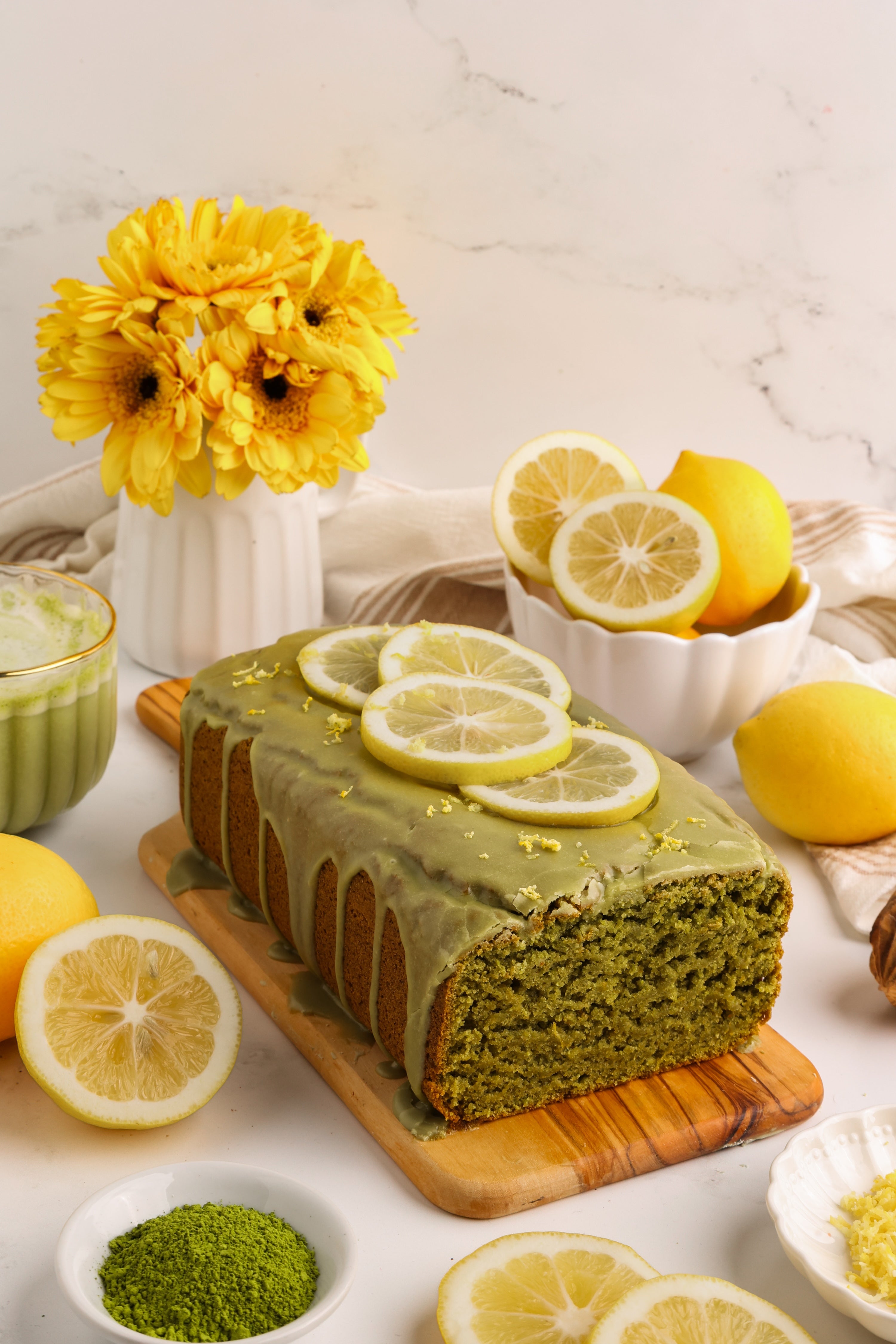 Gluten-free matcha lemon loaf with green matcha glaze made with Matcha Nude First Whisk Matcha, dairy-free and naturally sweetened.