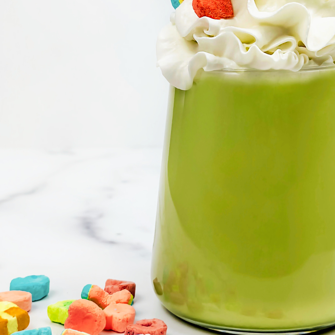 Iced matcha latte topped with whipped cream and colorful Lucky Charm marshmallows.