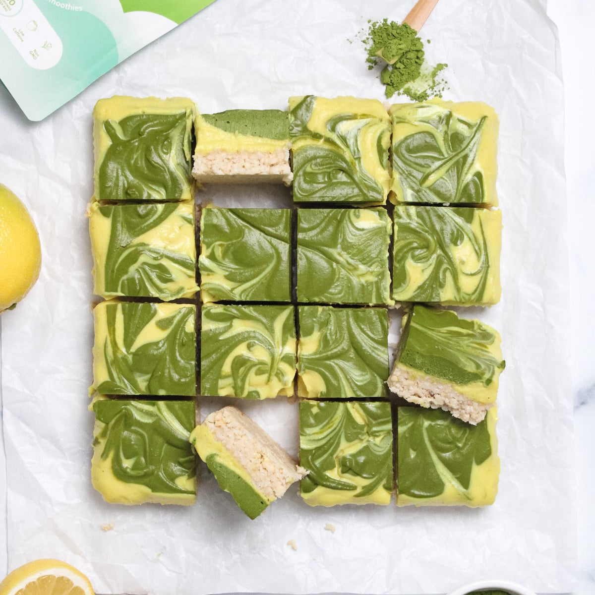 Matcha lemon cheesecake bars with swirled matcha topping and lemon slices