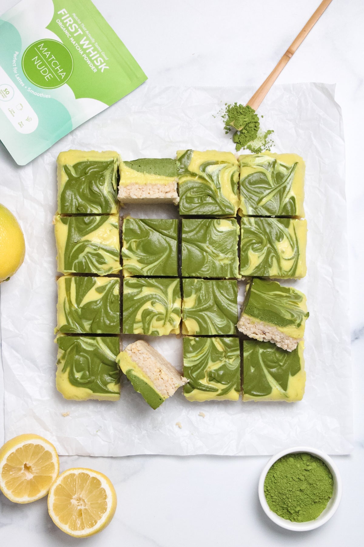 Matcha lemon cheesecake bars with swirled matcha topping and lemon slices