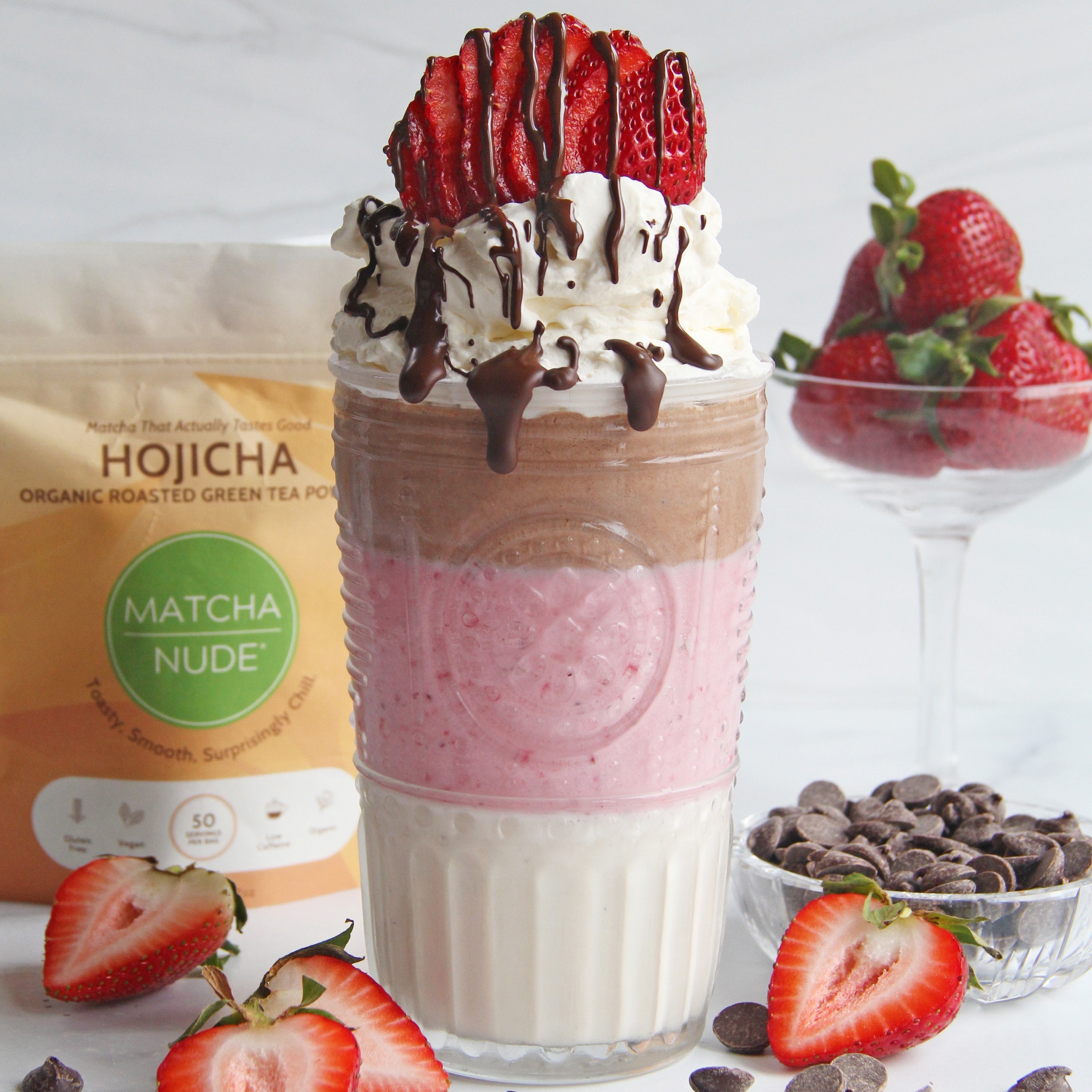 Neapolitan hojicha milkshake with strawberries, cream, and chocolate drizzle