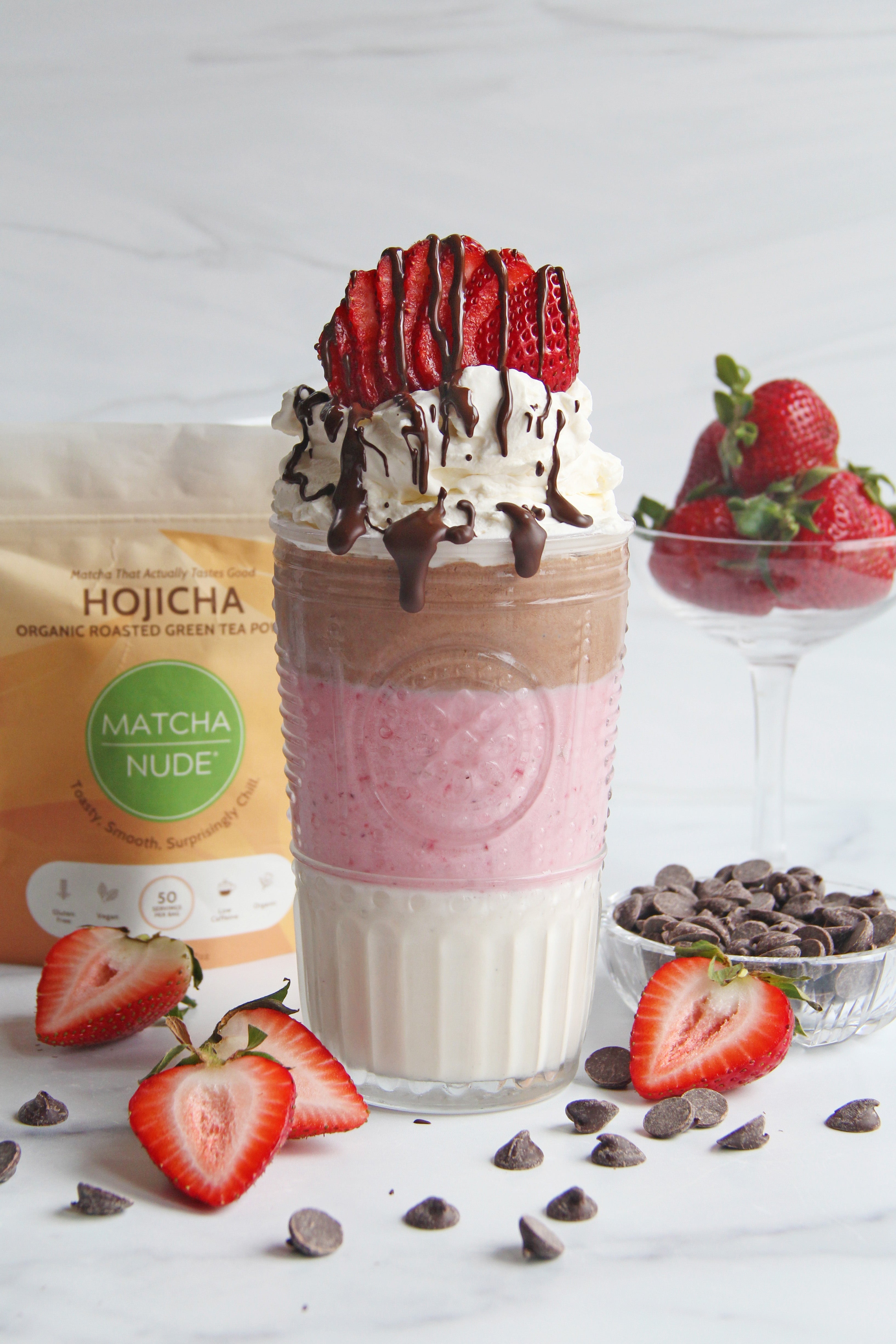 Neapolitan hojicha milkshake with strawberries, cream, and chocolate drizzle