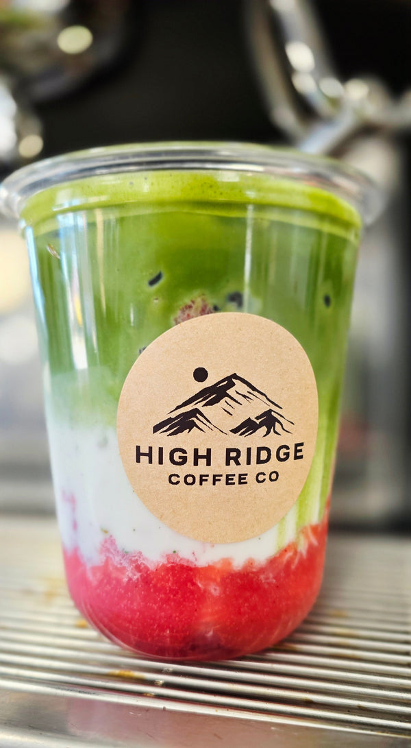 Berry Bliss Matcha from High Ridge Coffee Co featuring fresh strawberries, milk, and Matcha Nude ceremonial matcha layered over ice.