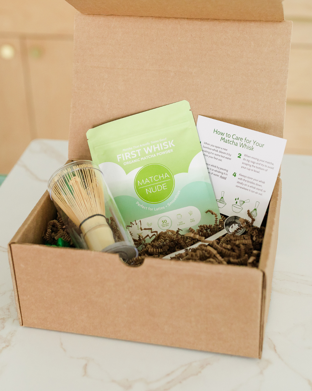 Matcha starter kit with First Whisk matcha, bamboo whisk, and spoon inside eco-friendly packaging box