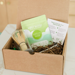 Matcha starter kit with First Whisk matcha, bamboo whisk, and spoon inside eco-friendly packaging box