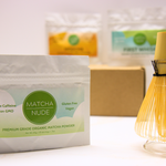 Close-up of Matcha Nude Premium Matcha sampler bag beside bamboo whisk