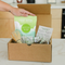 Hand holding First Whisk organic matcha above open matcha ritual set box