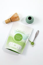 Load image into Gallery viewer, Premium organic matcha powder by Matcha Nude showcased with a traditional bamboo whisk and a green ceramic whisk holder. This sustainable matcha brand offers clean energy without jitters, featuring gluten-free, vegan, and non-GMO benefits. Perfect for matcha enthusiasts seeking quality and eco-friendly choices