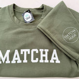Unisex green MATCHA crewneck sweatshirt with Matcha Nude sleeve logo – printed by Moonlight Makers in Asheville, NC