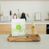 Premium Matcha Experience Kit with organic matcha, bamboo whisk, glass bowl and whisk holder on wooden tray